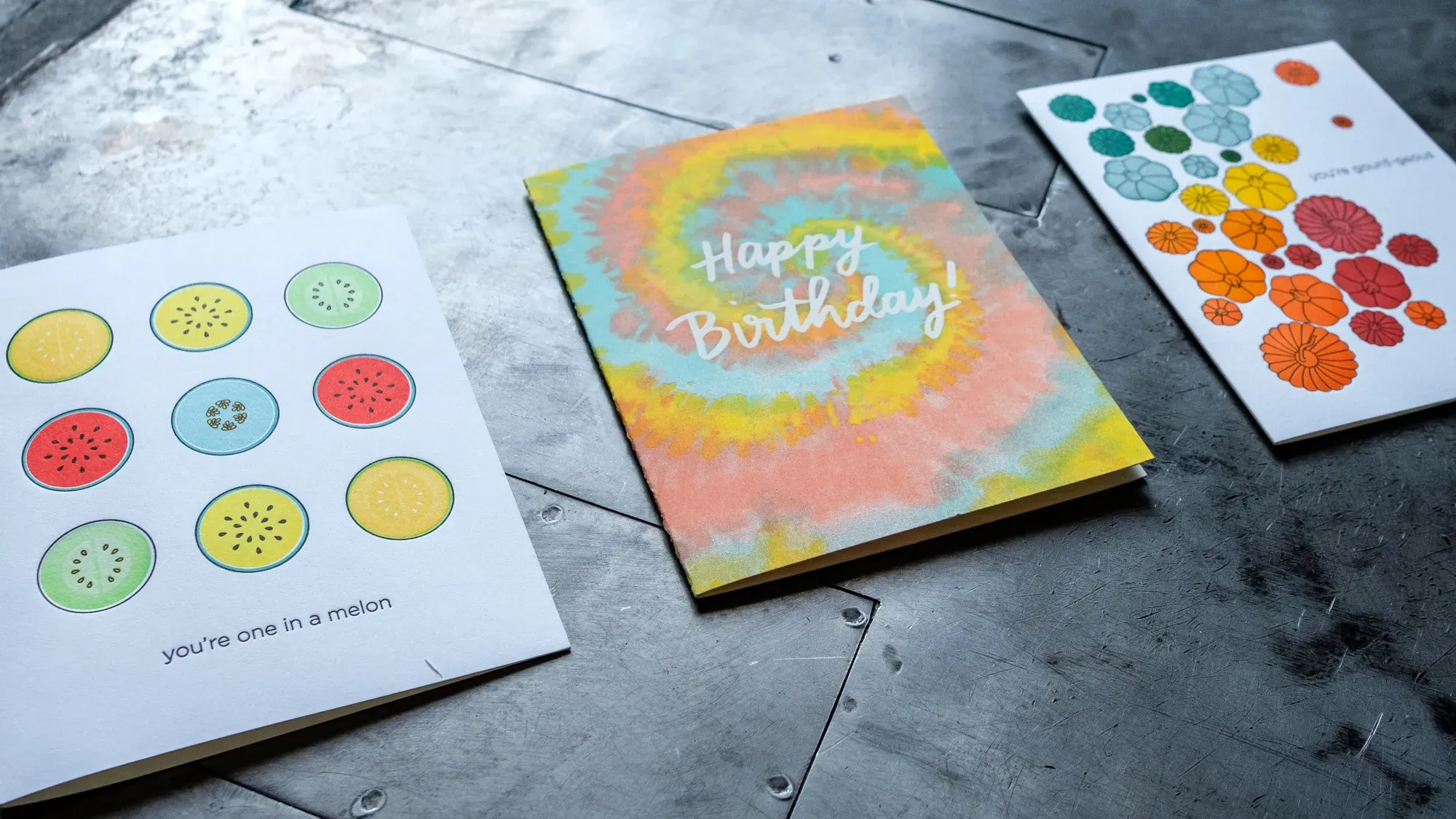 Letterpress printed cards laid out on the steel bed of a press