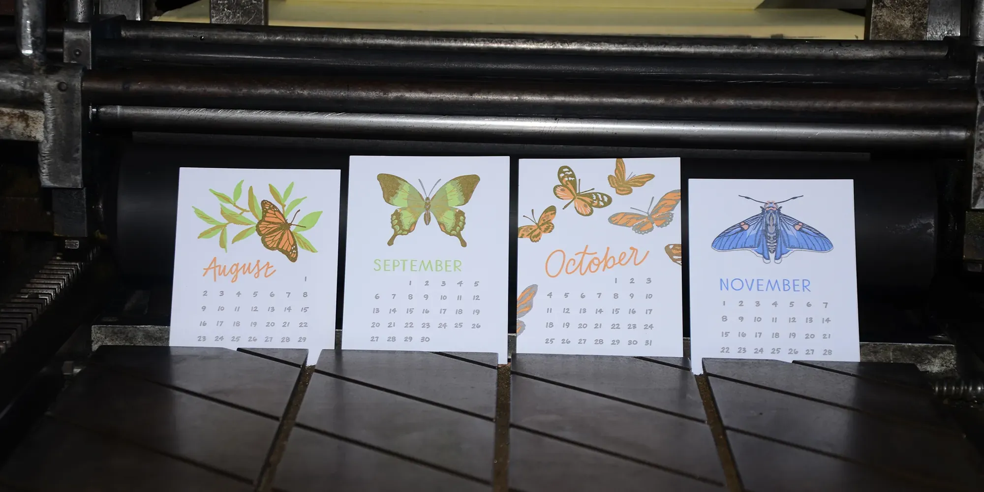 Letterpress printed calendar cards standing on the bed of a press