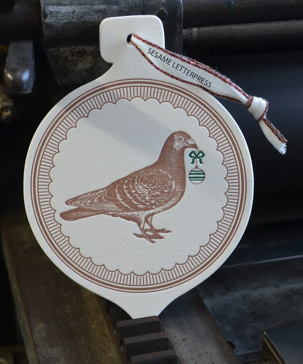 A letterpress printed pigeon ornament with fine line detail
