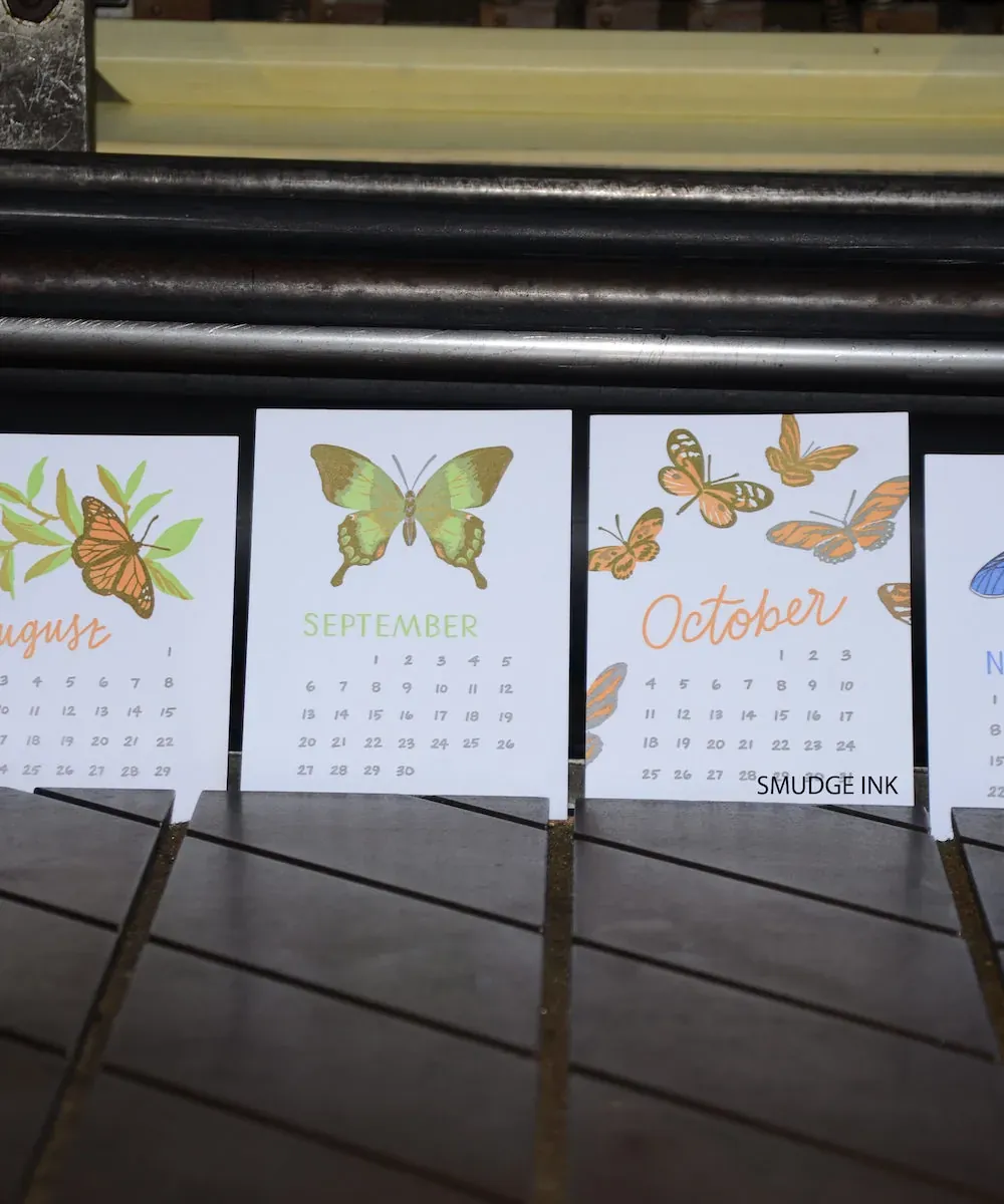 Letterpress printed butterfly calendar cards standing on a press